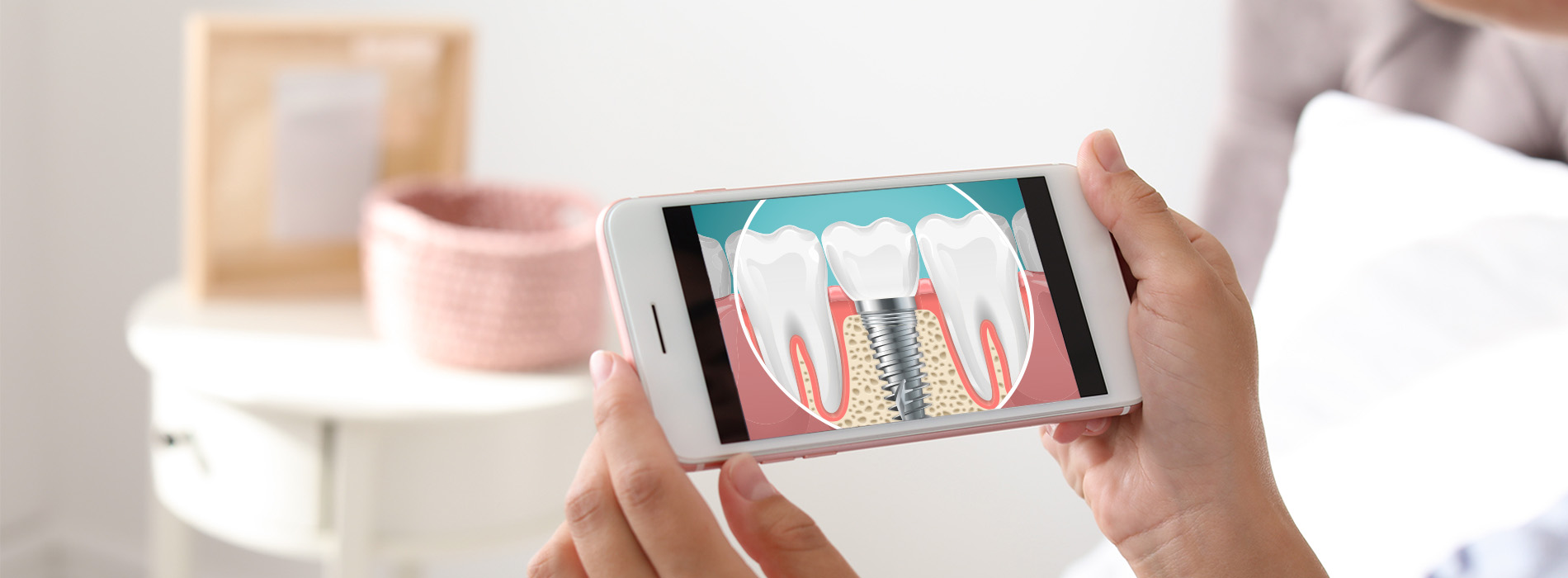A person holding a smartphone displaying two images of teeth, with the top half of the device showing an animated toothbrush cleaning a tooth while the bottom half shows a real-life toothbrush placed on a surface.
