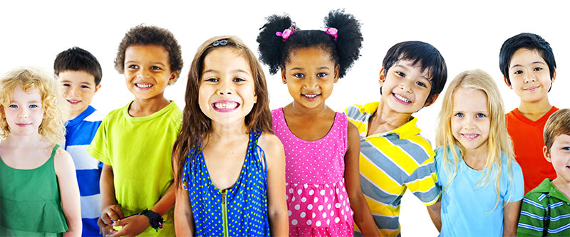The image depicts a group of children standing together, with each child wearing a different colored shirt, against a plain background.